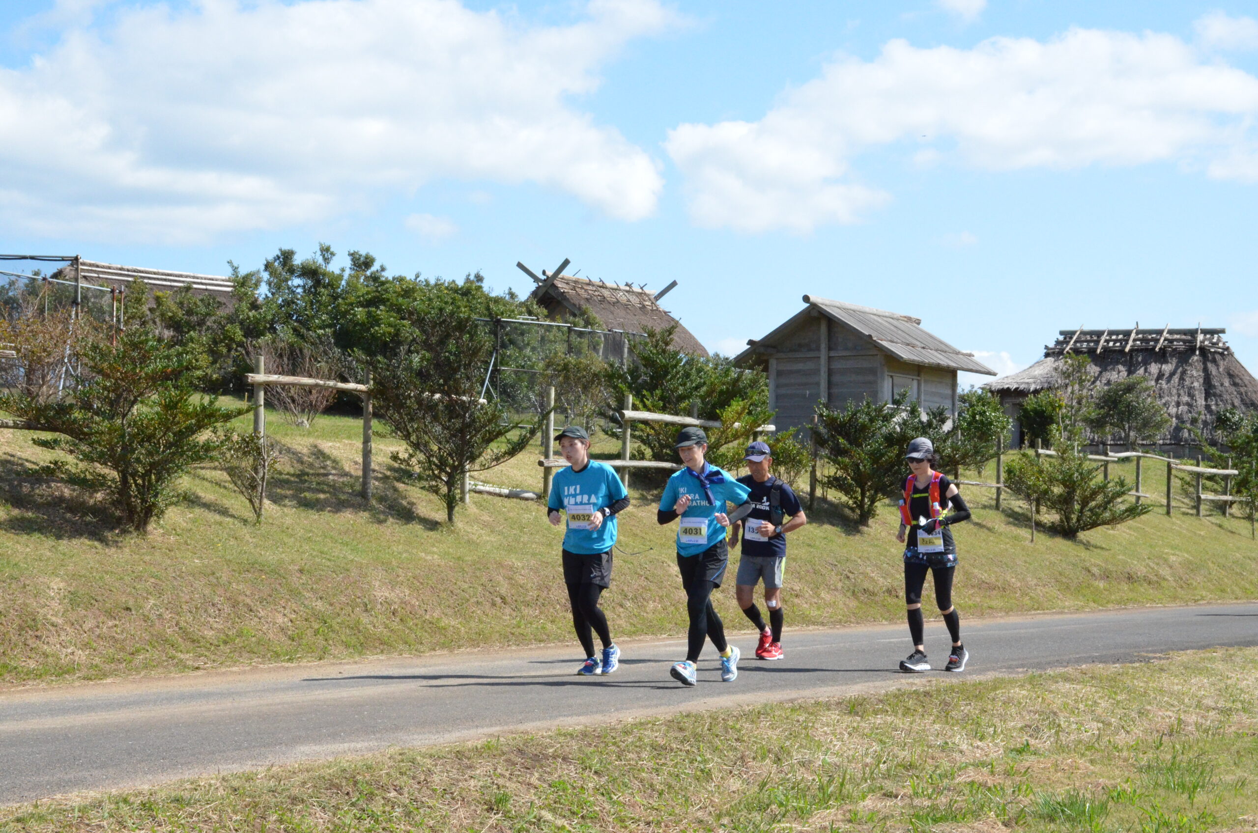 Runners on the Iki Ultra Marathon coastal course, Iki Island